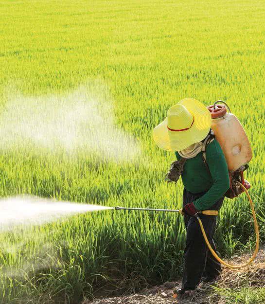 Rolnik spryskujacy pole